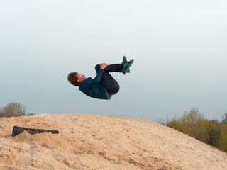 Children and teenagers have fun on the white sand. parkour