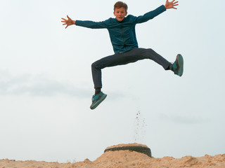 Children and teenagers have fun on the white sand. parkour