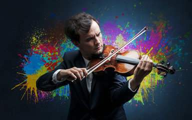 Young classical violinist musician with colorful splotch wallpaper
