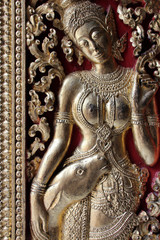 sculptured door in a buddhist temple (Wat Xieng Thong) in Luang Prabang (Laos)