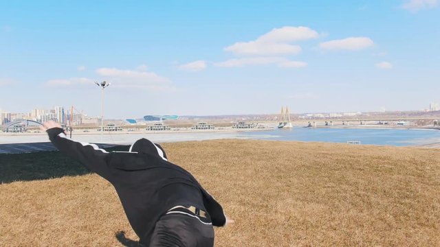 A man performing acrobatic tricks on the grass