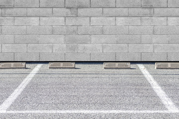 Empty Outdoor car parking space and stone block wall - Powered by Adobe