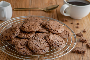 chocolate chip cooking with a cup of coffee on wooden table