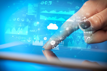 Businessman using tablet with flying application icons around
