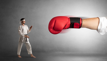 Little man fighting with a giant red boxing glove
