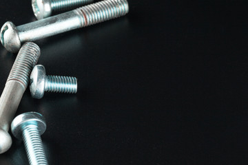 screws on black background