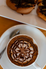 hot Coffee in a cup and bread with chocolate