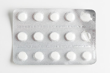 Silver blister packs pills isolated on white
