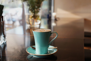 A cup of coffee on the table in a cafe