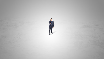 Young businessman standing alone in the middle of an empty space
