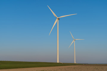 Fototapeta premium Modern wind turbines generating clean energy in the countryside. Groningen, Holland.