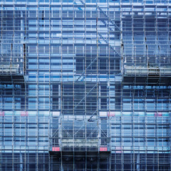 Obraz na płótnie Canvas Glass Facade Building Construction industry with scaffold Architecture detail background