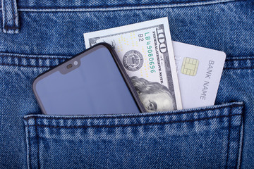 Smartphone, U.S. hundred dollars  and credit card in the back jeans pocket