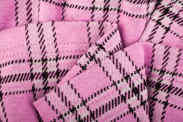 The crumpled texture of wool pink fabric in the cell