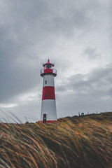 Fototapeta na wymiar Lighthouse with clouds at the coast