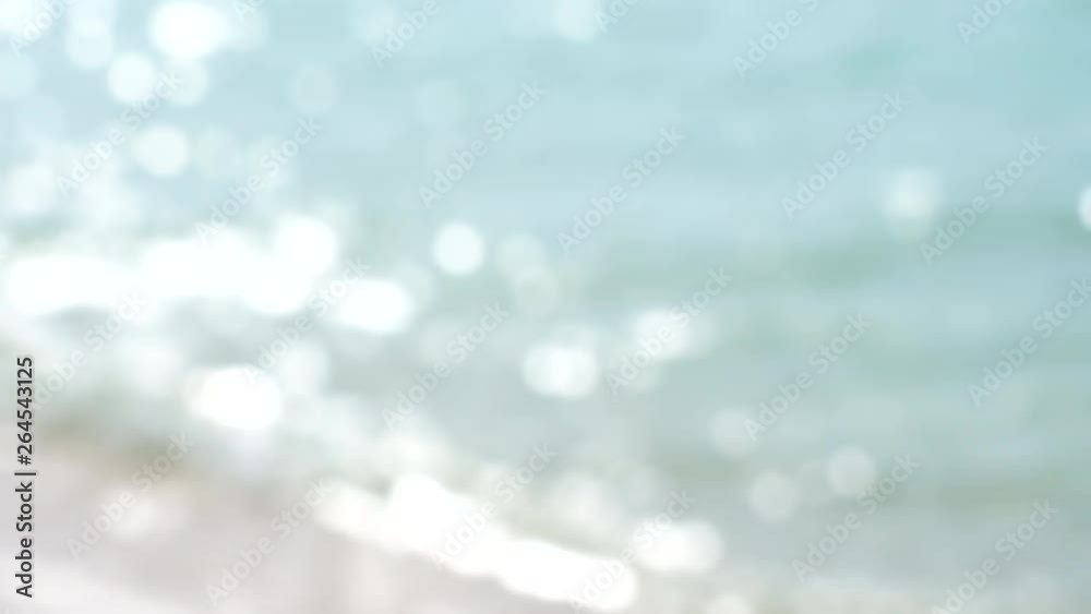 Wall mural blurred sea wave and summer day background blur with bokeh sparkle light blink