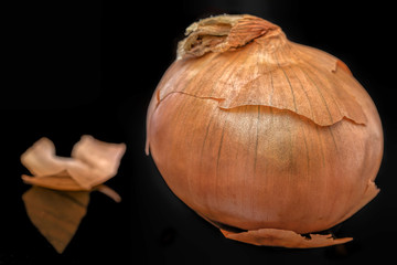 Single onion on black background