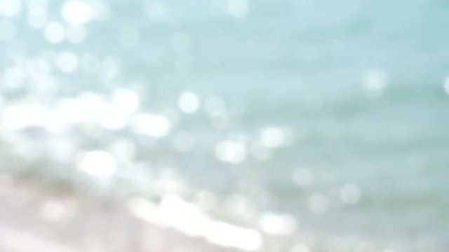 blurred sea wave and summer day background blur with bokeh sparkle light blink