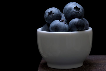 Blueberries macro studio shot on wooden top