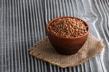 Grain buckwheat on a gray wooden background