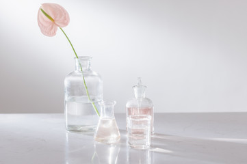 Beautiful composition with perfume samples and flowers on table