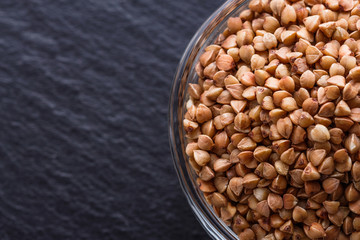 Grain buckwheat on a dark stone background