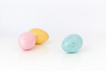 Three coloured easter eggs on white background