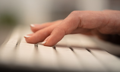 Hand typing on keyboard with office concept
