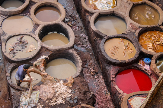 FEZ, MOROCCO - November 1, 2012: Leather dying in a traditional tannery in the city Fez, Morocco