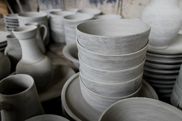 FEZ, MOROCCO - November 1, 2012: Handmade pottery goods stacked in columns in a pottery workshop in Fez, Morocco.