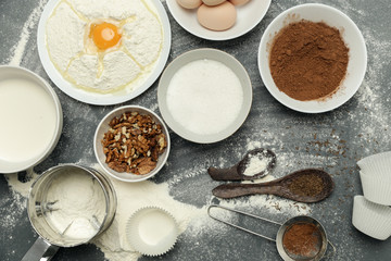 Creating a recipe, Top view of the basic baking ingredients and kitchen utensils on the dark background, cooking concept