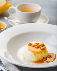 dessert pana cotta with see-buckthorn orange sauce in white plate restaurant