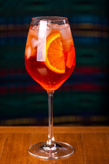 Aperol spritz cocktail in glass on wooden table in the interior of the restaurant.