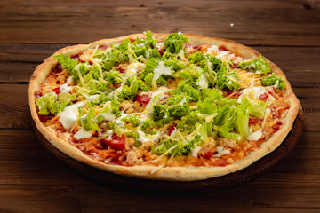Appetizing pizza on a wooden background