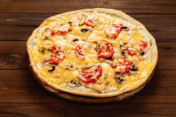 Appetizing pizza on a wooden background