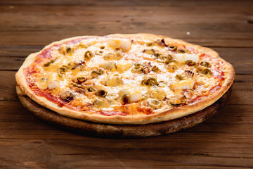 Appetizing pizza on a wooden background