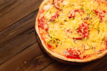 Appetizing pizza on a wooden background