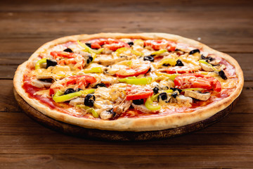 Appetizing pizza on a wooden background