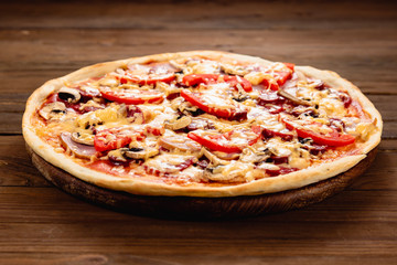 Appetizing pizza on a wooden background
