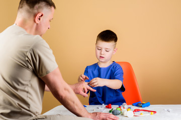 Medical examination. Hospital worker. Medical service. Analysis laboratory. Kid little doctor sit table medical tools. Health care. Pediatrician concept. Boy cute child and his father doctor
