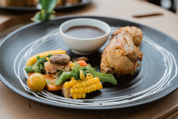 half chicken grill served with mushroom sauce paste and veggie