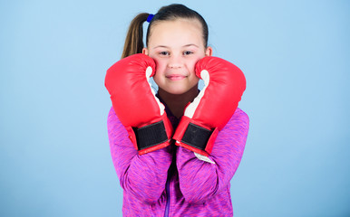Contrary to stereotype. Boxer child in boxing gloves. Female boxer. Sport upbringing. Boxing...