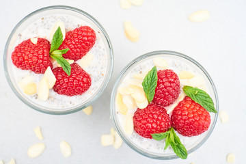 chia pudding with raspberries in a small glass bowl