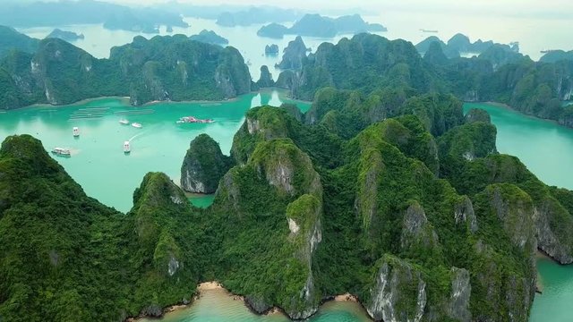 Unique aerial drone flight over natural rocks green tops Halong bay islands from sea blue azure water. Wild natural untouched seascape. Asia Vietnam. Best Travel sight. 
