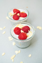chia pudding with raspberries in a small glass bowl