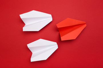 winner red  paper aircraft on red background -
