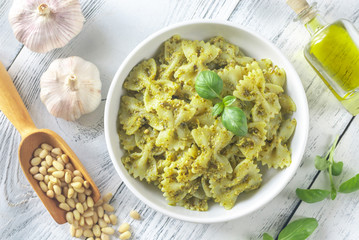 Portion of farfalle with pesto with ingredients