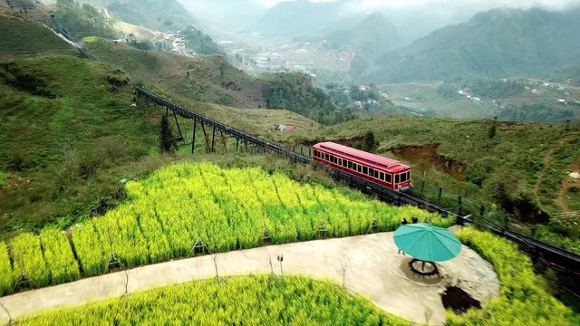 Aerial forward descent Mountain red train railway. Majestic panorama rice fields mountain canyon view of Valley Vietnam 