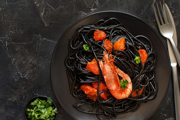 Squid ink pasta with prawns and tomatoes
