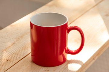 Red coffee cup on wooden desk